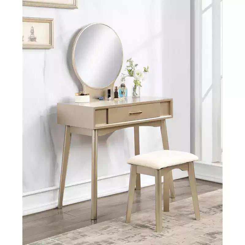 Coiffeuse moderne avec miroir rond, rangement organisé, tabouret assorti pour chambre à coucher, finition dorée, design peu encombrant